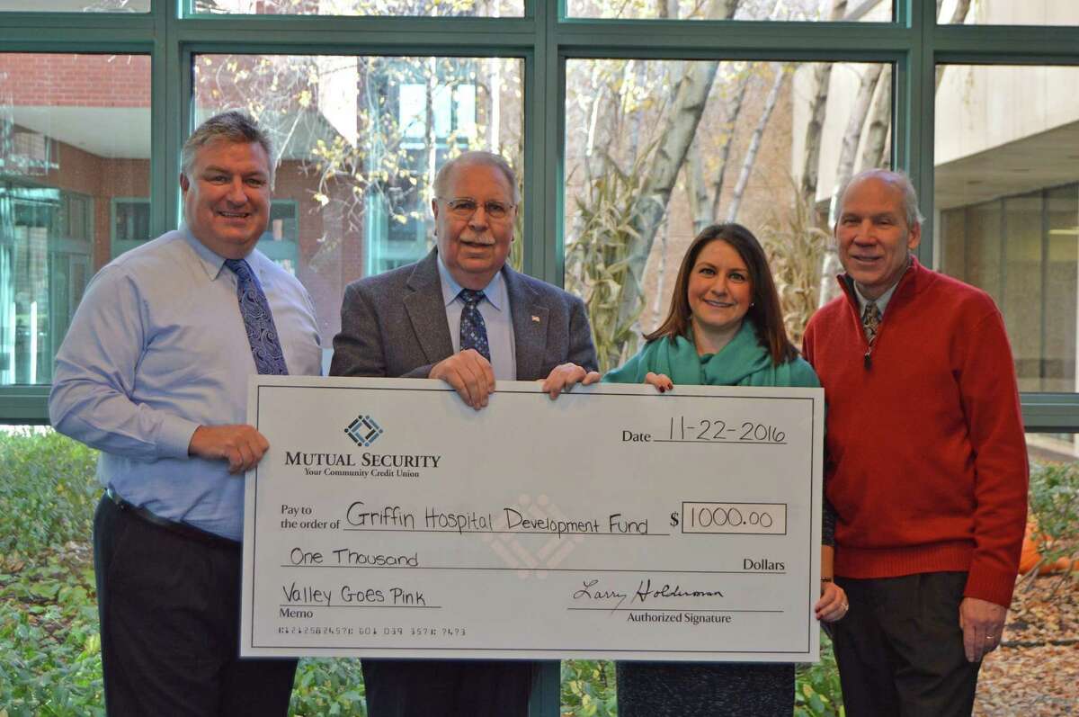 Griffin Hospital Events Coordinator Lisa Nista recently received a $1,000 check from, left to right, Mutual Security Credit Union?’s President & CEO Larry Holderman, Executive VP Hank Baum and Bill Purcell, Valley Chamber of Commerce President for the Valley Goes Pink campaign. Photo courtesy of Griffin Hospital.