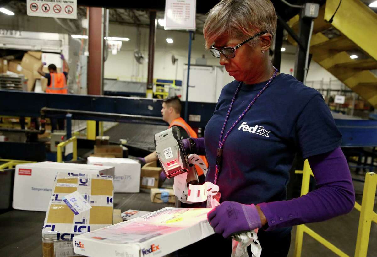 FedEx workers race to meet record demand