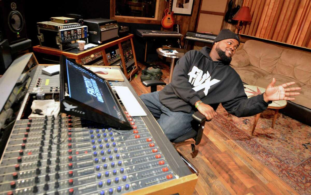 Norwalk Rapper FNX sits behind the mixing board at The Factory Underground in Norwalk on Wednesday, where he has just released his debut album “DJ Juelz Presents: FNX Music Vol. 1.” FNX will be using it to raise awareness for feeding hungry families in the community through a crowd funding campaign