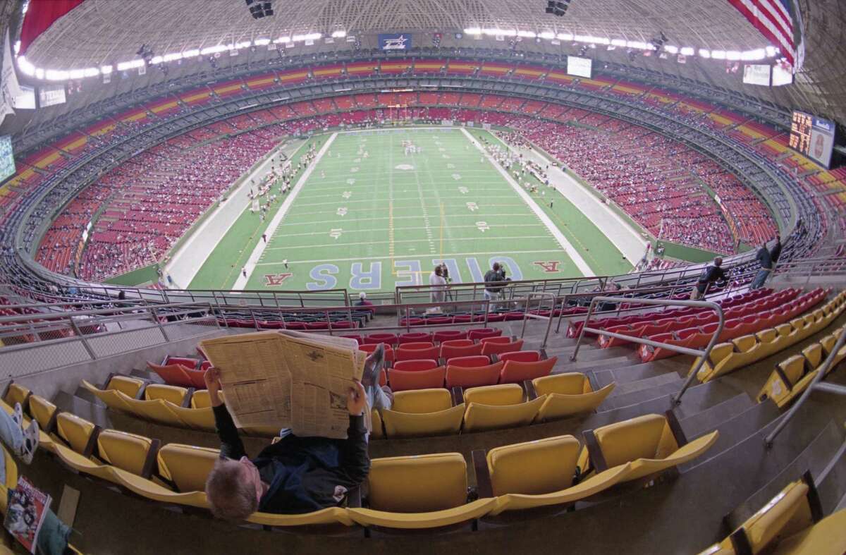 Houston Oilers v Cincinnati Bengals, Astrodome. In the quiet of the upper deck, a fan in the sparse crowd reads the Sunday paper during the final Oilers game played in the Astrodome, a loss to the Cincinnati Bengals, Dec. 15, 1996. (Smiley N. Pool/Chronicle)