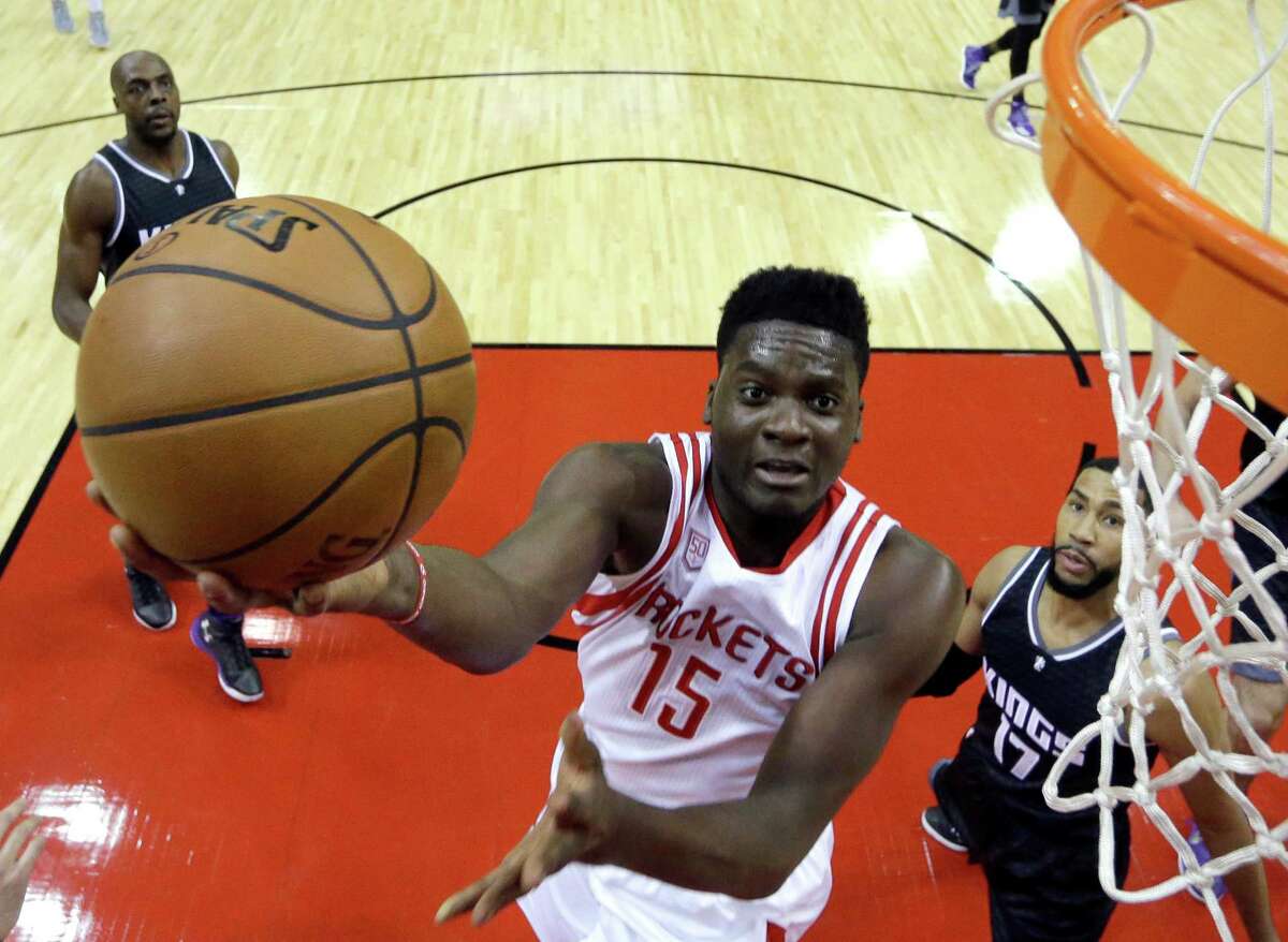Houston Rockets' Clint Capela (15) shoots as Sacramento Kings' Garrett Temple (17) defends during the first half of an NBA basketball game Wednesday in Houston.