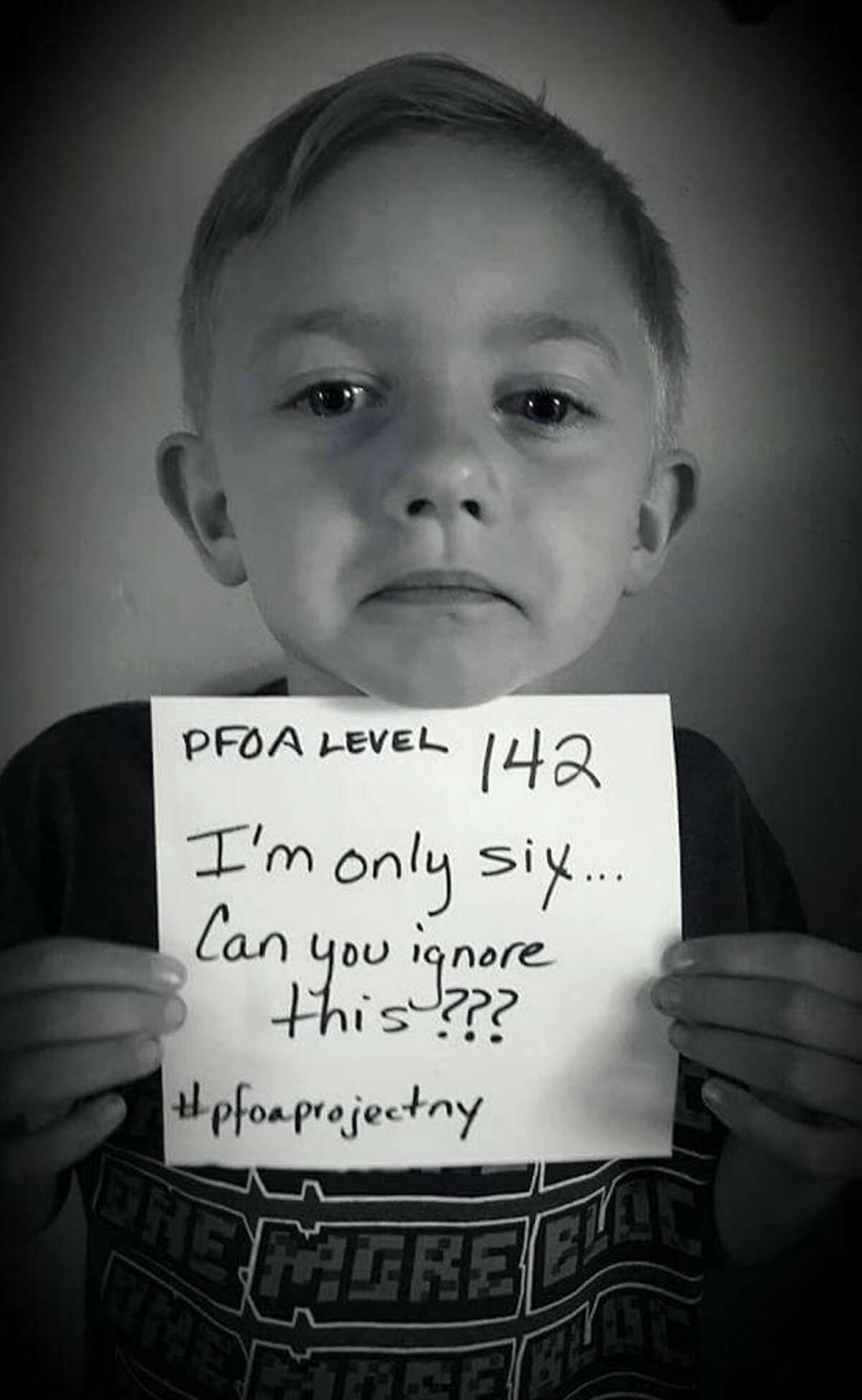 Hoosick Falls resident, Corey Aldrich, 6, displays a sign with his body's PFOA level after receiving the results of a recent blood test conducted by the state. The photo was posted on Twitter by parents, Josh and Nikki Aldrich. (Courtesy Josh and Nikki Aldrich)