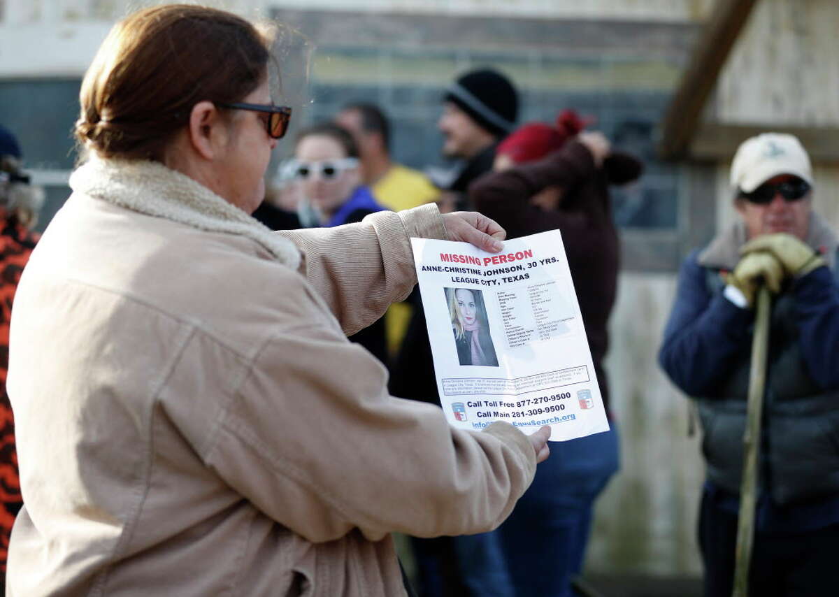 An Equusearch member holds up a missing persons poster as they started looking for Anne-Christine Johnson, a missing 30-year-old woman, Thursday,Dec. 15, 2016 in League City.