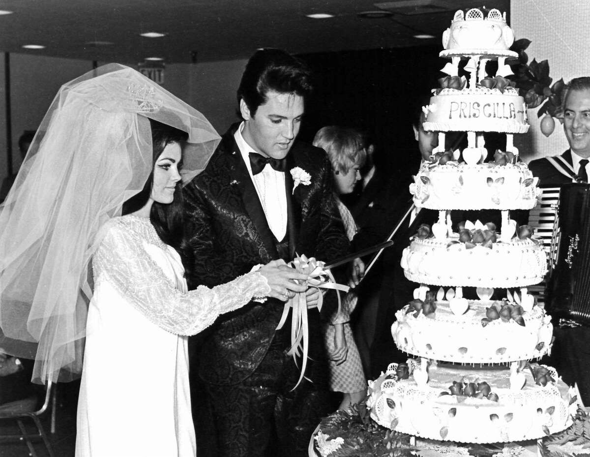 Elvis and Priscilla Presley cut their wedding cake after exchanging nuptials in the Aladdin Hotel in Las Vegas.