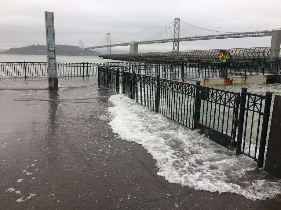 High tides causing some low-level flooding, water flowing onto ...