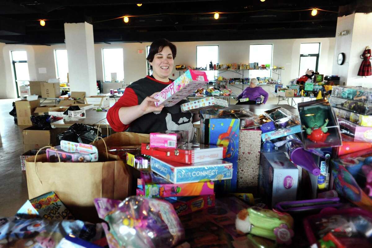 Amy Serino, of Stamford, finds age appropriate toys for a Christmas gift bag inside the temporary space for Toys for Tots on Canal St. in Stamford, Conn. on Thursday, Dec. 15, 2016. Toys for Tots in Stamford still needs 3,000 toys to meet the requests it received this Christmas.