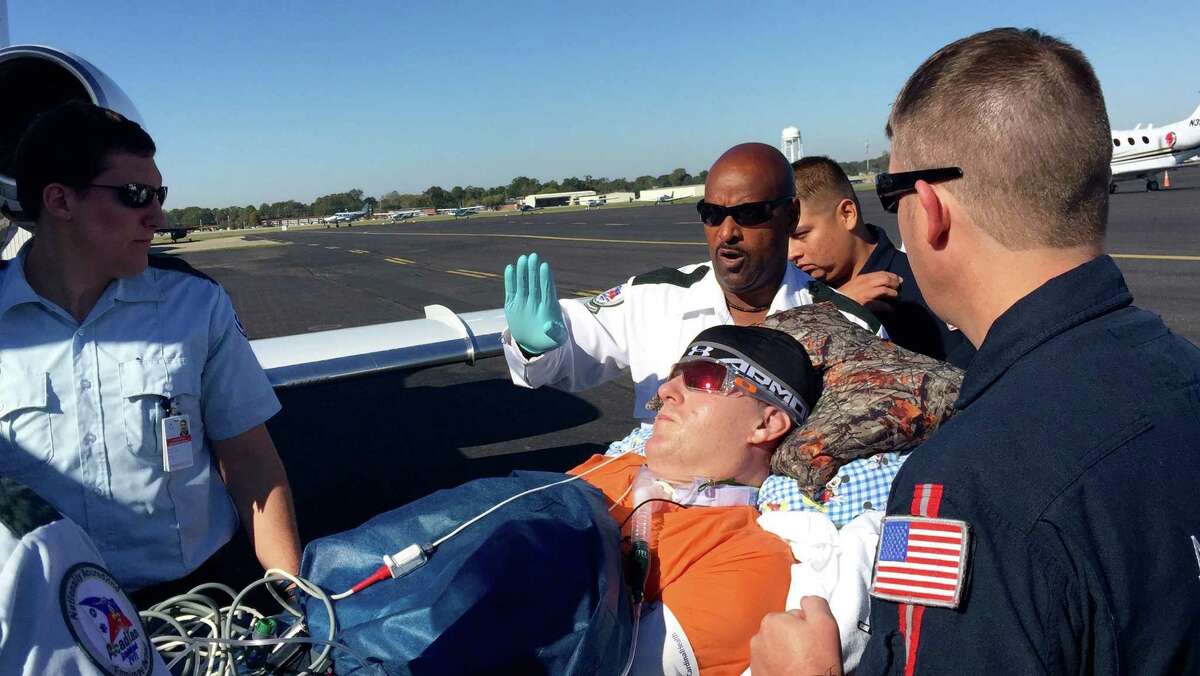 East Baton Rouge Parish Sheriff's Deputy Nicholas Tullier is taken to a plane at an airport in Baton Rouge, La., on Wednesday, Nov. 16, 2016, to travel to a rehabilitation hospital in Texas. Tullier had been treated at a hospital in Baton Rouge since a July 17 shooting that killed three other Baton Rouge, Louisiana, law-enforcement officers. (Kiran Chawla/WAFB-TV via AP)