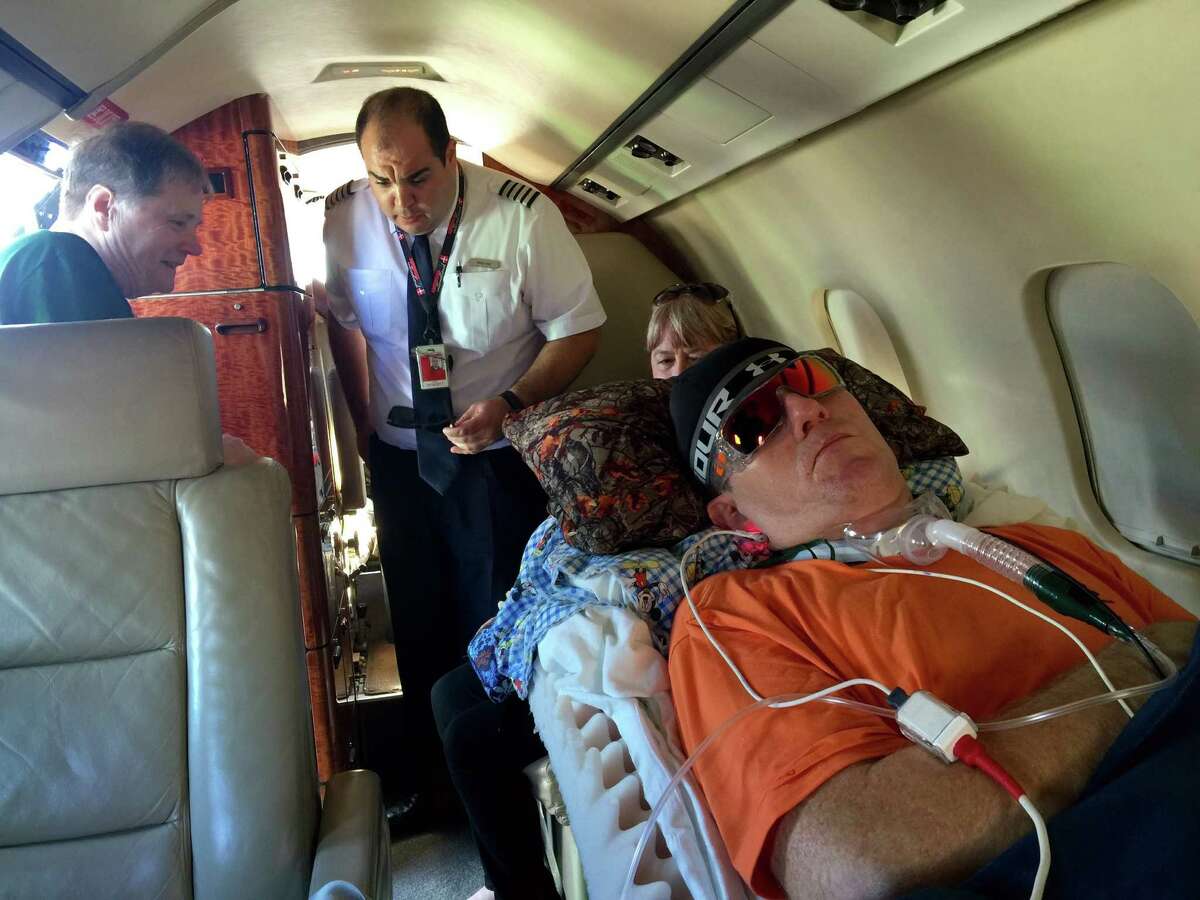 East Baton Rouge Parish Sheriff's Deputy Nicholas Tullier lies in a plane at an airport in Baton Rouge, La., on Wednesday, Nov. 16, 2016, to travel to a rehabilitation hospital in Texas. Tullier had been treated at a hospital in Baton Rouge since a July 17 shooting that killed three other Baton Rouge, Louisiana, law-enforcement officers. (Kiran Chawla/WAFB-TV via AP)