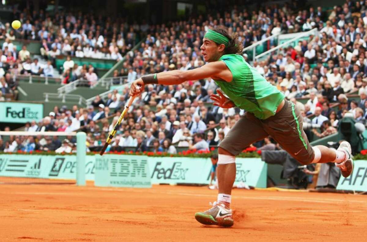 PARIS - JUNE 06: Rafael Nadal of Spain hits a forehand during the Men's Singles Semi Final match against Novak Djokovic of Serbia on day thirteen of the French Open at Roland Garros on June 6, 2008 in Paris, France. (Photo by Mike Hewitt/Getty Images)
