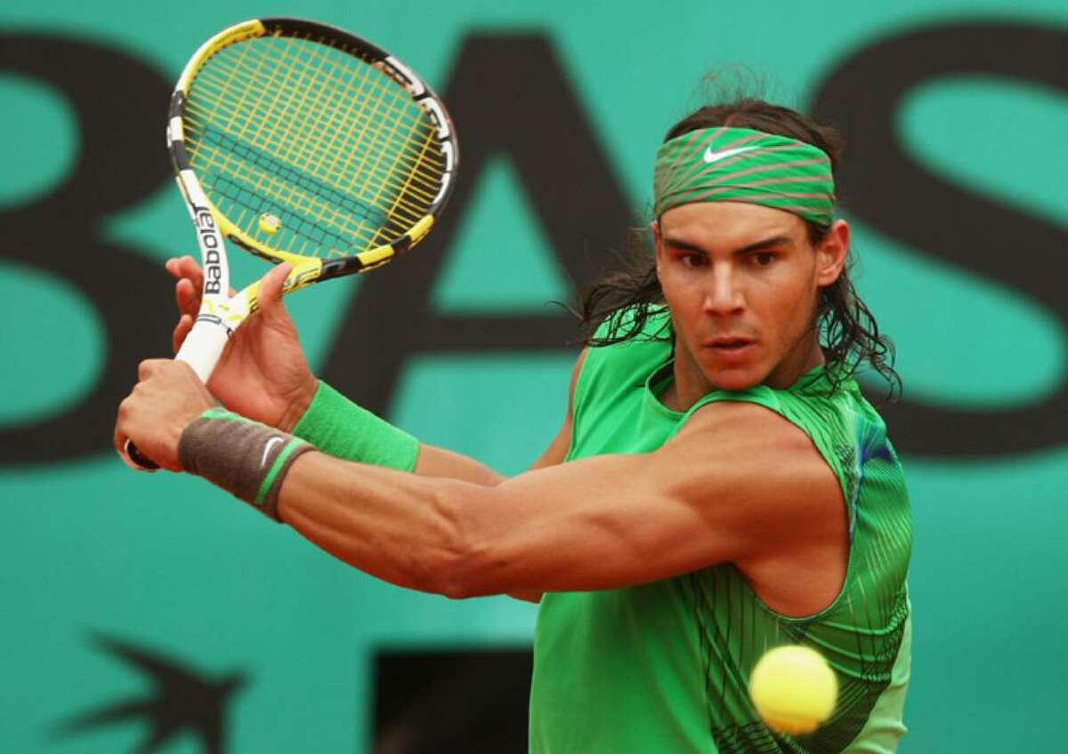 PARIS - JUNE 06: Rafael Nadal of Spain hits a backhand during the Men's Singles Semi Final match against Novak Djokovic of Serbia on day thirteen of the French Open at Roland Garros on June 6, 2008 in Paris, France. (Photo by Mike Hewitt/Getty Images)