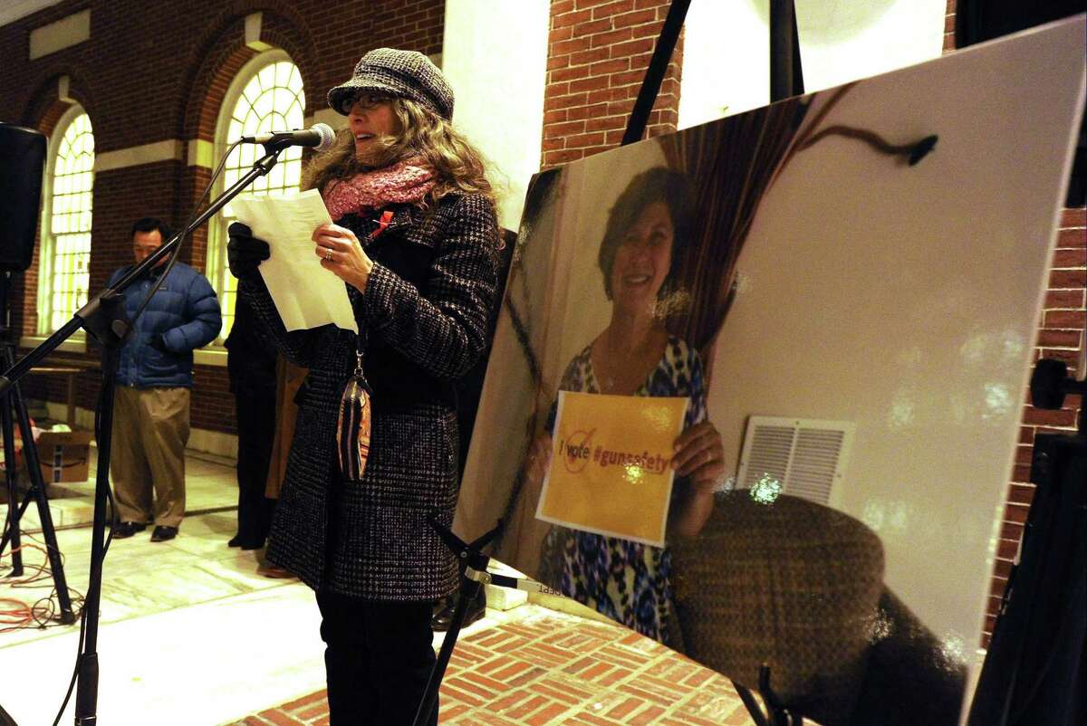 Shira Tarantino with The ENOUGH Campaign stands with a photo of Judith Martin, Stamford Mayor David Martin late wife, who was an out spoken advocate to end gun violence, as she welcomes attendees to the fourth annual Stamford Vigil of Hope to End Gun Violence in front of Ferguson Library in Stamford on Dec. 15, 2016. The event attended by two dozen individuals which included civic and state representatives honored the lives lost to the epidemic of gun violence in America, one day after the fourth anniversary of the Sandy Hook shootings.