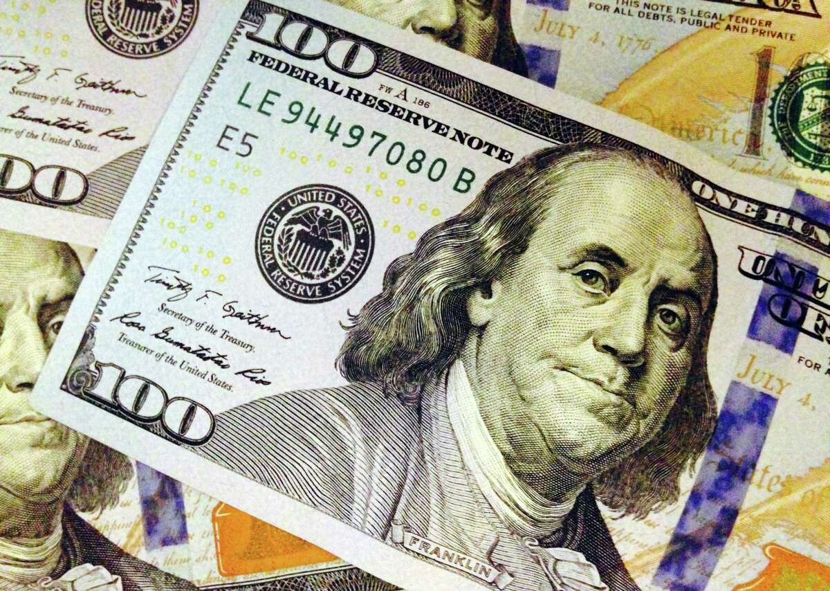FILE - In this Feb. 2, 2015, file photo, parts of U.S. $100 bill are seen in Washington. A new study says Republicans may be handing wealthy Americans a big tax cut by repealing President Barack ObamaÂ?’s health care law. The richest households would get an average tax cut of $197,000, according to the analysis released Thursday by the nonpartisan Tax Policy Center, a joint venture of the Urban Institute and the Brookings Institution. (AP Photo/Jon Elswick, File)