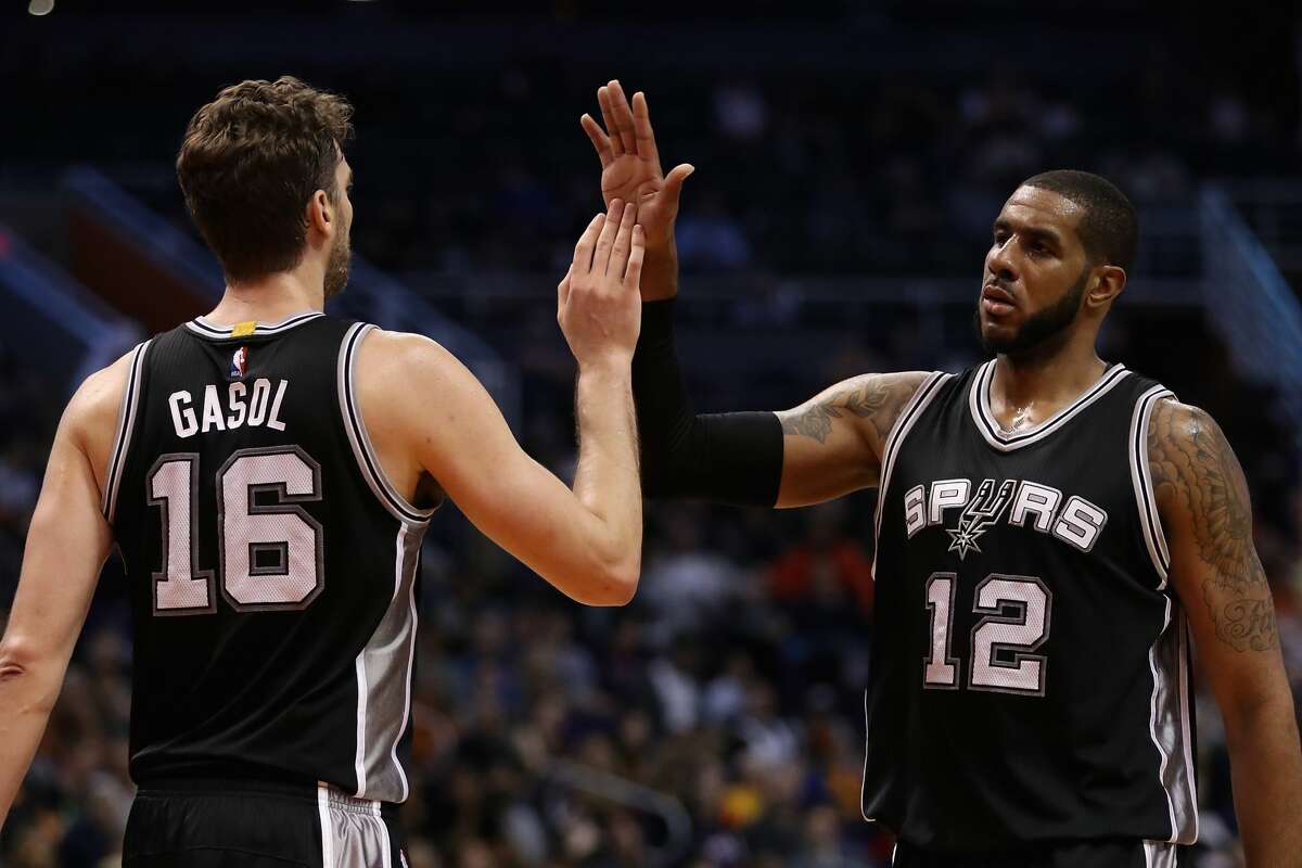 PHOENIX, AZ - DECEMBER 15: LaMarcus Aldridge #12 of the San Antonio Spurs high fives Pau Gasol #16 after scoring against the Phoenix Suns during the second half of the NBA game at Talking Stick Resort Arena on December 15, 2016 in Phoenix, Arizona. The Spurs defeated the Suns 107-92. NOTE TO USER: User expressly acknowledges and agrees that, by downloading and or using this photograph, User is consenting to the terms and conditions of the Getty Images License Agreement. (Photo by Christian Petersen/Getty Images)