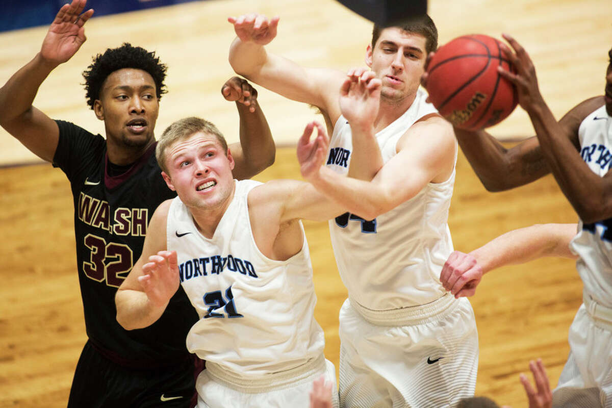 THEOPHIL SYSLO | For the Daily News Northwood's Zach Allread and Charlie Ryan and Walsh's Trey Fletcher fight for a rebound in a game at Northwood University on Thursday.