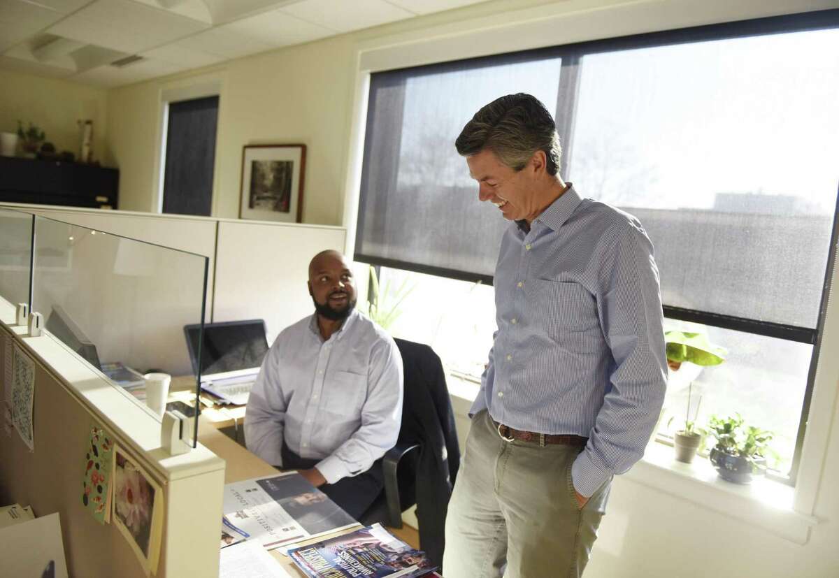 Capital Institute Director of Communications Julian McKinley, left, and Founder and President John Fullerton chat in the Capital Institute office in Greenwich, Conn. Wednesday, Dec. 14, 2016. Capital Institute is a non-partisan think-tank launched in 2010 by former JPMorgan Managing Director John Fullerton that promotes free enterprise economics to contribute to global causes.