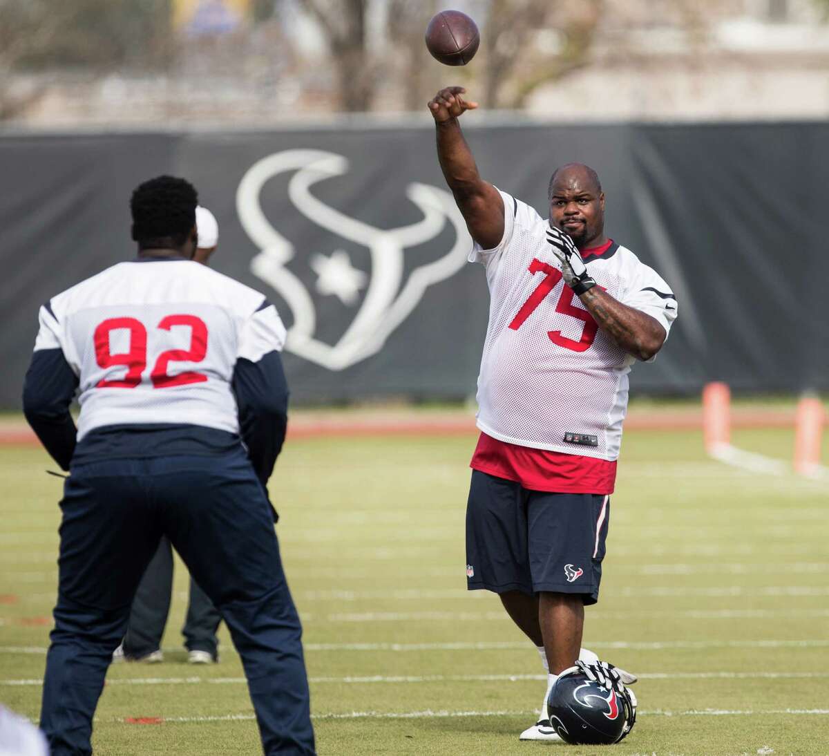 Houston Texans nose tackle Vince Wilfork (75) throws a football to defensive tackle Brandon Dunn (92) during warm ups, while preparing for the AFC Wildcard Round against the Kansas City Chiefs, during practice at The Methodist Training Center on Thursday, Jan. 7, 2016, in Houston. ( Brett Coomer / Houston Chronicle )