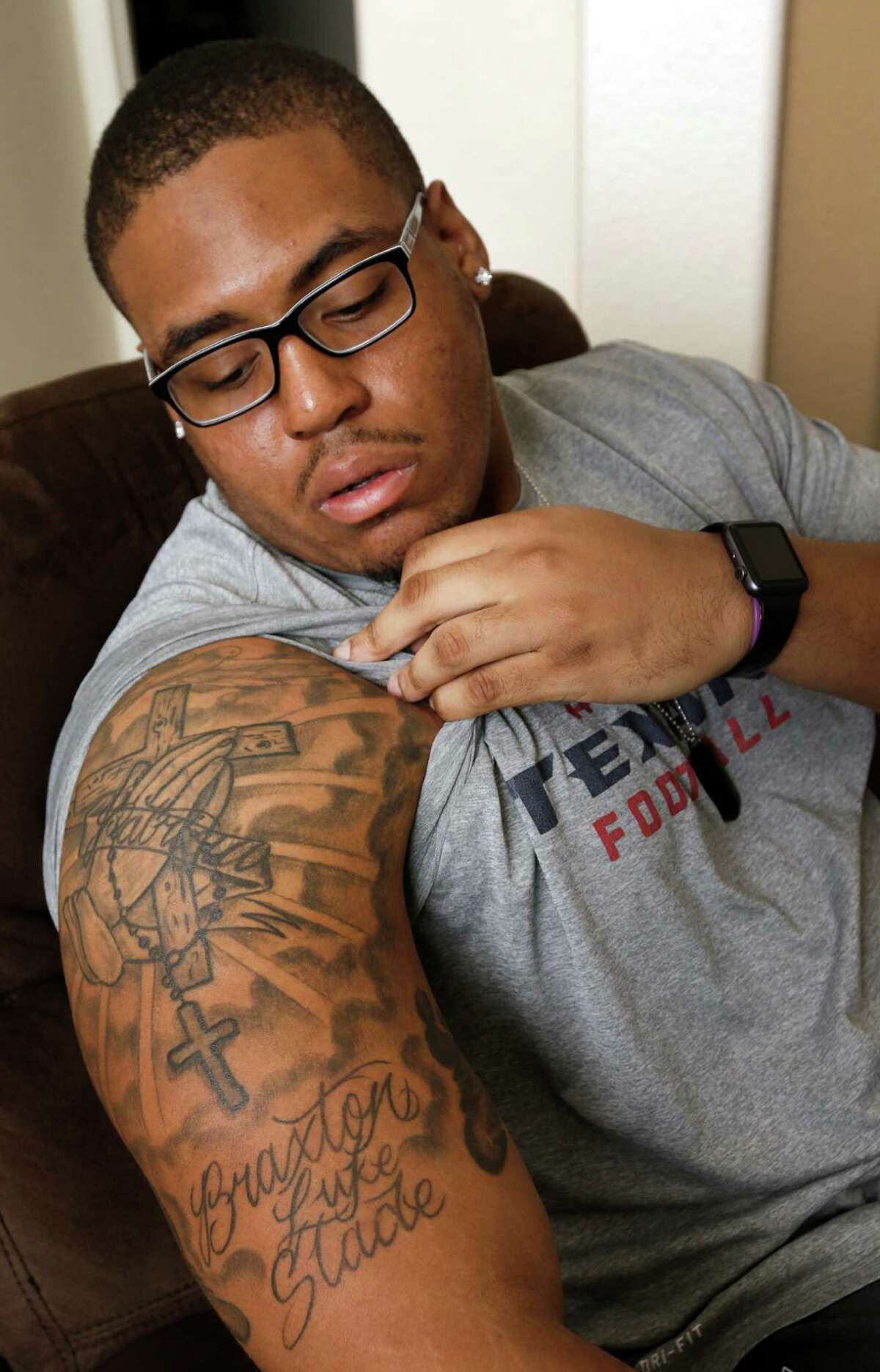 Texans practice squad player Chad Slade talks about his tattoos in honor of his late grandmother and his 14-month-old son, Braxton Slade, while watching the Texans and Packers game on television at his home Sunday, Dec. 4, 2016, in Pearland. ( Melissa Phillip / Houston Chronicle )