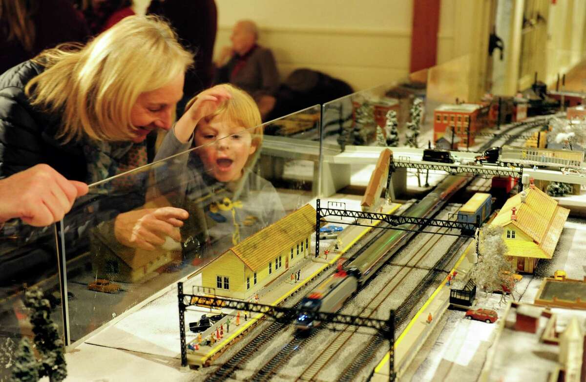 Sheila Cashel, of Fairfield, points to the model train for her grandson Declan, 2, as it moves around the track during the 11th Annual Holiday Express Train Show at the Fairfield Museum and History Center on Dec. 9on.