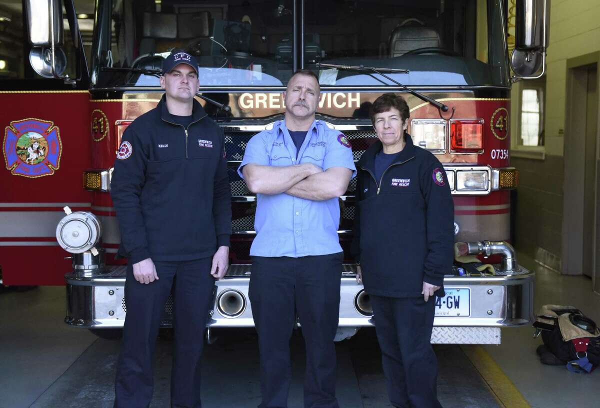 Firefighter Christopher Kelly, left, Fire Lt. Dennis Frulla and firefighter Whitney Welch pose in front of their firetruck at the Glenville Fire Department in the Glenville section of Greenwich. At the end of November, the paid Greenwich fire departments began operating with a three-person crew instead of a four-person crew in an effort for the town to save money.