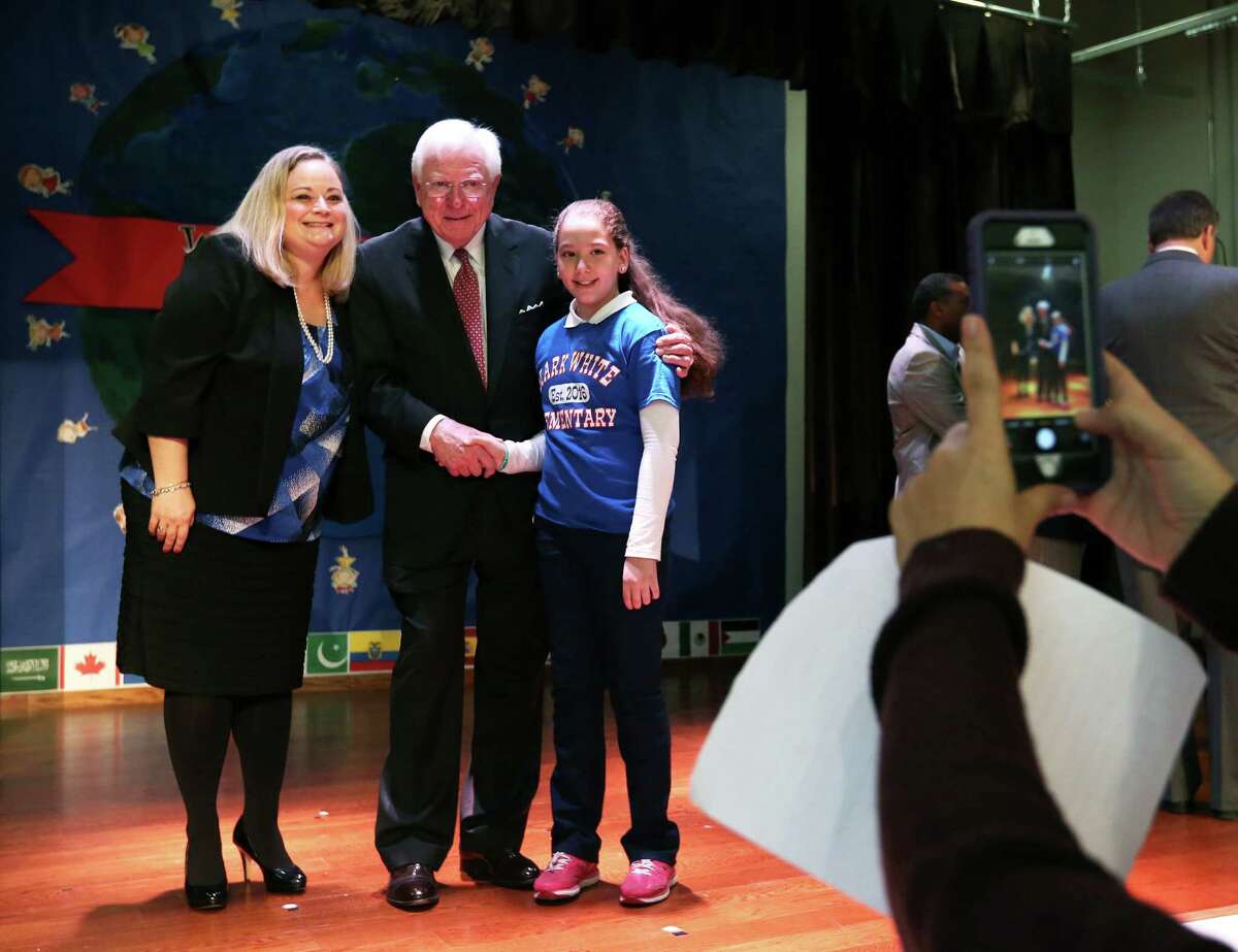 Principal Lisa Hernandez and former Texas Gov. Mark White pose with student Baayan Badarna during the opening ceremony of Mark White Elementary on Monday, Dec. 12, 2016, in Houston. (Annie Mulligan / Freelance)