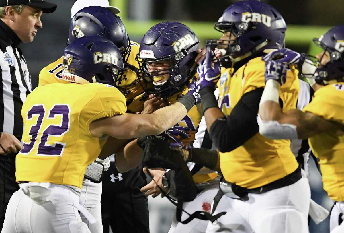 Mary Hardin-Baylor linebacker Matt Cody is the center of attention as he is congratulated after his game-clinching interception in the final minute.