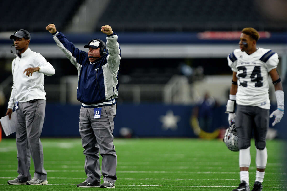 West Orange-Stark coach Cornel Thompson celebrates after a touchdown during the second quarter of the Class 4A-Division II state final against Sweetwater at AT&T Stadium in Arlington on Friday. Photo taken Friday 12/16/16 Ryan Pelham/The Enterprise