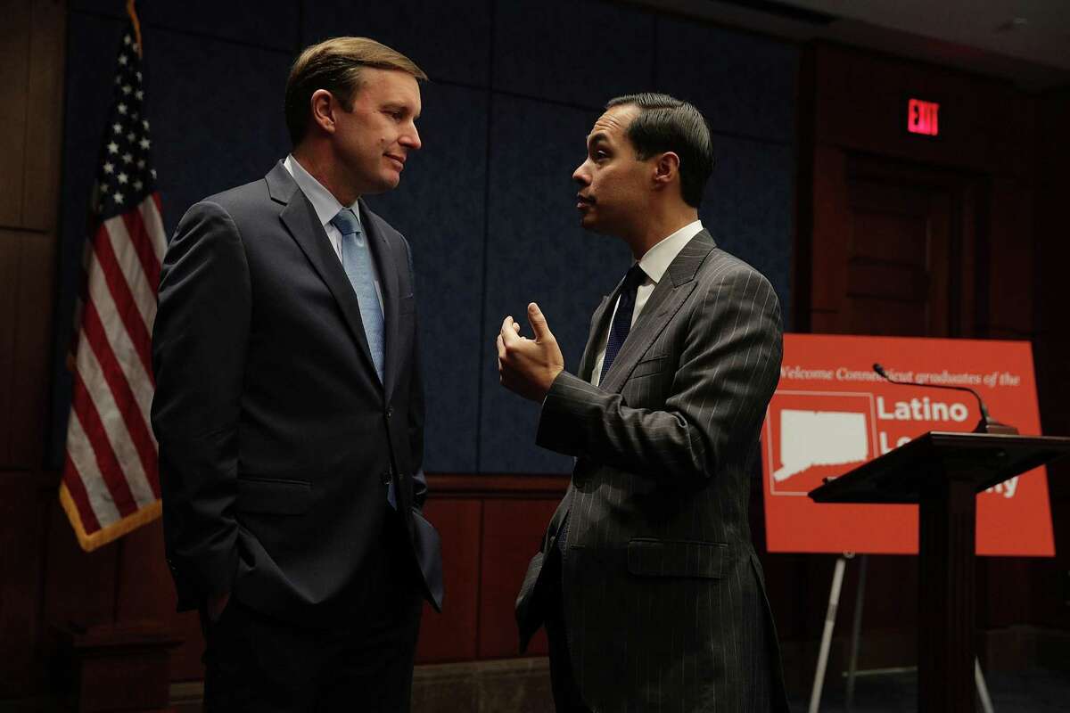 WASHINGTON, DC - DECEMBER 06: U.S. Sen. Chris Murphy (D-CT) (L) talks to Secretary of Housing and Urban Development Julian Castro (R) December 6, 2016 on Capitol Hill in Washington, DC. Sec. Castro was on the Hill to meet with members of the Latino Leadership Academy of Connecticut. (Photo by Alex Wong/Getty Images)