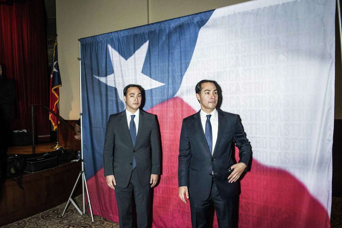 Brothers Joaquin, left, and Julian Castro, right, wait to take photographs with well-wishers during a birthday party for the brothers on Friday, September 16, 2016 in San Antonio, Texas. The brothers Castro spent part of their Christmas holiday attacking President-elect Donald Trump on social media.
