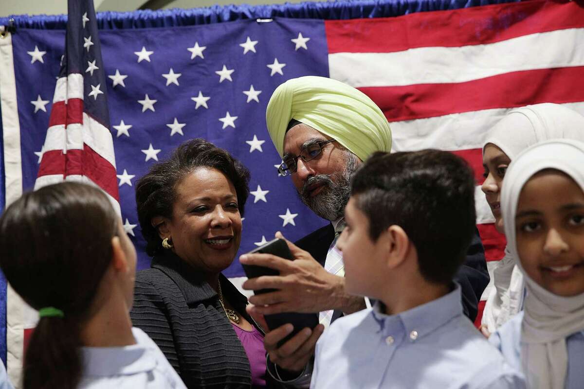U.S. Attorney General Loretta Lynch shares a moment with Rajwant Singh, founder and chairman of the Sikh Council on Religion and Education. New research has shown that religious minorities in the U.S. are likely more educated than American Christians.