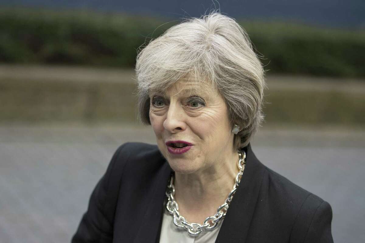 Theresa May, U.K. prime minister, speaks to members of the media as she arrives for the European Union (EU) leaders' summit in Brussels, Belgium, on Thursday, Dec. 15, 2016. May wants to trigger the Brexit process by the end of March and the Lords panel said an early goal in the talks should be to Â?“agree a transitional period so as to prevent U.K.-based financial-services firms from restructuring or relocating on the basis of a worst-caseÂ?’ scenario.Â?” Photographer: Jasper Juinen/Bloomberg