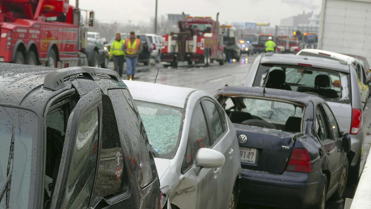 Mangled vehicles rest on the northbound Interstate 95 shoulder at the Washington Boulevard exit after a series of crashes that shut down I-95 in Baltimore, Md., on Saturday, Dec. 17, 2016. An ice storm created slick conditions, sparking a chain reaction pile-up involving dozens of vehicles. (Karl Merton Ferron/The Baltimore Sun via AP)