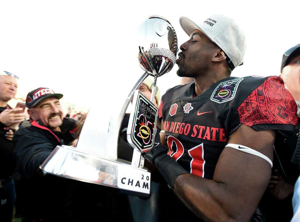 San Diego State wide receiver Eric Judge kisses the championship trophy after San Diego State defeated Houston 34-10 in the Las Vegas Bowl NCAA college football game Saturday, Dec. 17, 2016, in Las Vegas. (AP Photo/David Becker)