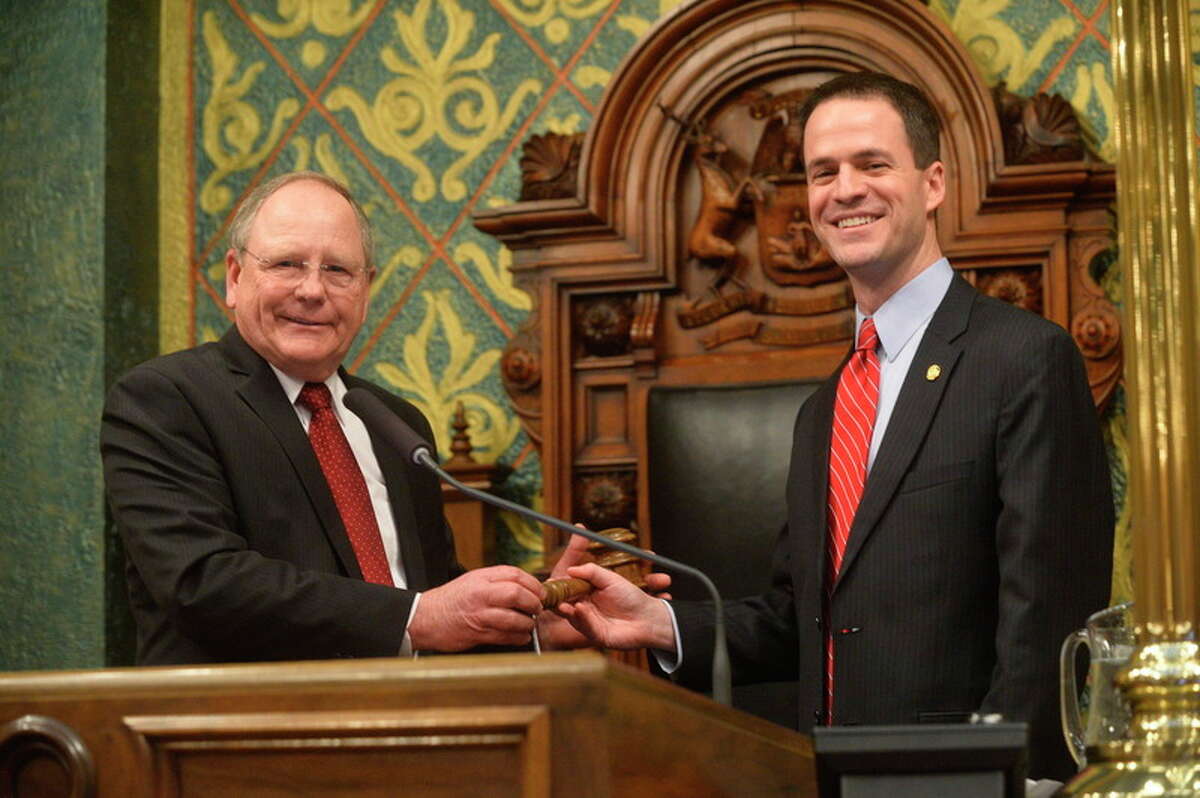 House Speaker Kevin Cotter, R-Mount Pleasant, right, is handed the gavel in the House chambers immediately following his election during the Opening Day of the 98th Michigan Legislature. Cotter was elected Speaker of the House by his peers in a unanimous vote.