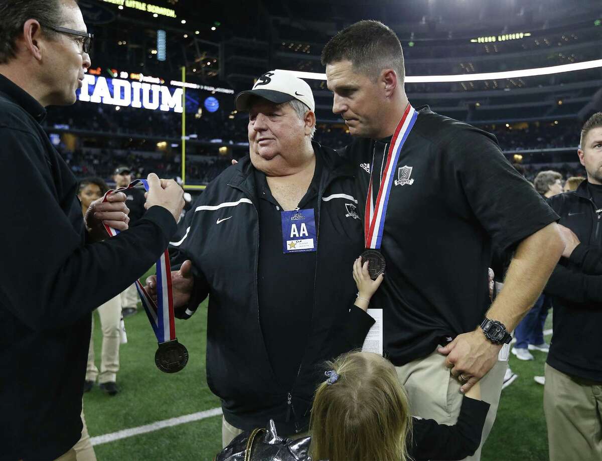Retired Schertz-Cibolo-Universal City School District athletic director Robert Lehnhoff (center) receives a medal along with his son and Steele head coach Scott Lehnhoff after the Knights fell to DeSoto in the Class 6A Division II state championship football game at AT&T Stadium in Arlington on Dec. 17, 2016. DeSoto defeated Steele, 39-29.