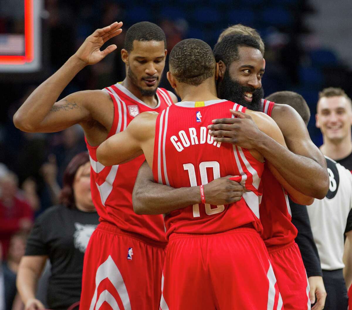 Rockets guard James Harden, right, and teammates Eric Gordon (10) and Trevor Ariza celebrate their overtime win over the Timberwolves. The three combined for 59 points and 10 of the team's 3-point shots.