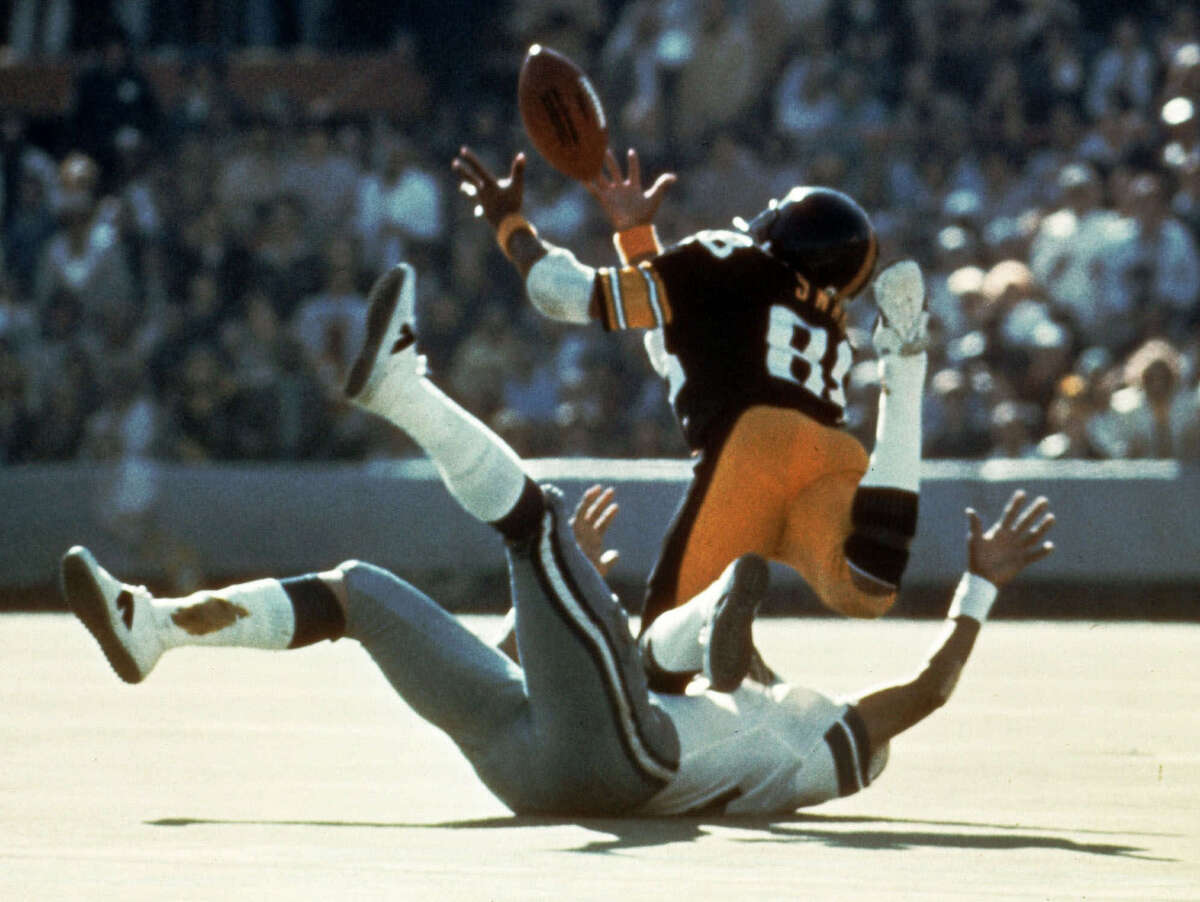 FILE--Pittsburgh Steelers wide receiver Lynn Swann (88) dives as he catches a pass from quarterback Terry Bradshaw during Super Bowl X at the Orange Bowl in this Miami, Fla., in this Jan. 18, 1976 photo. Swann was one of seven elected into the Pro Football Hall of Fame, Saturday, Jan. 27, 2001. (AP Photo/File)