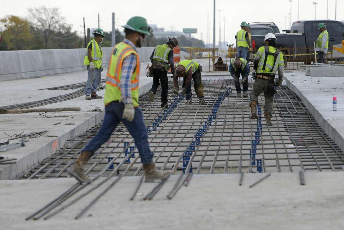 Workers tie rebar along the U.S. 290 westbound main lanes on Dec. 13, 2016.