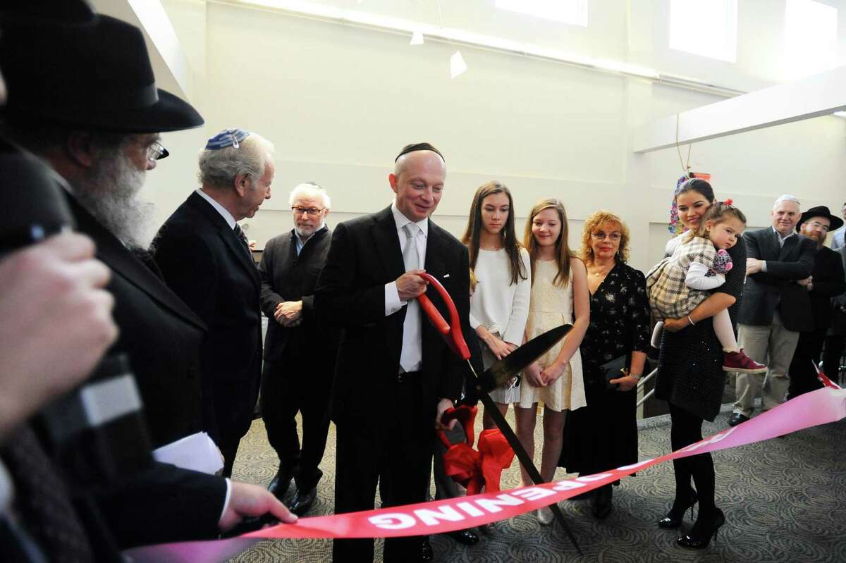 Igor Tulchinsky, CEO of Worldquant, a quantitative investment management firm based in Greenwich, cuts the dedication ribbon during a ceremony at the Chabad Lubavitch Center of Greater Stamford in Stamford on Sunday.