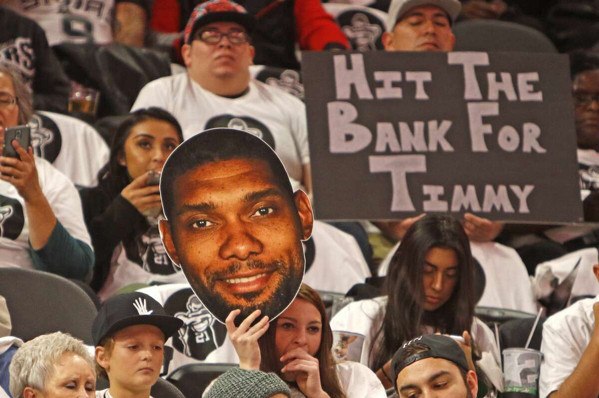 SAN ANTONIO,TX - DECEMBER 18: San Antonio Spurs fans hold signs honoring Tim Duncan before the start of their game against the New Orleans Pelicans at AT&T Center on December 18, 2016 in San Antonio, Texas. NOTE TO USER: User expressly acknowledges and agrees that , by downloading and or using this photograph, User is consenting to the terms and conditions of the Getty Images License Agreement. (Photo by Ronald Cortes/Getty Images)
