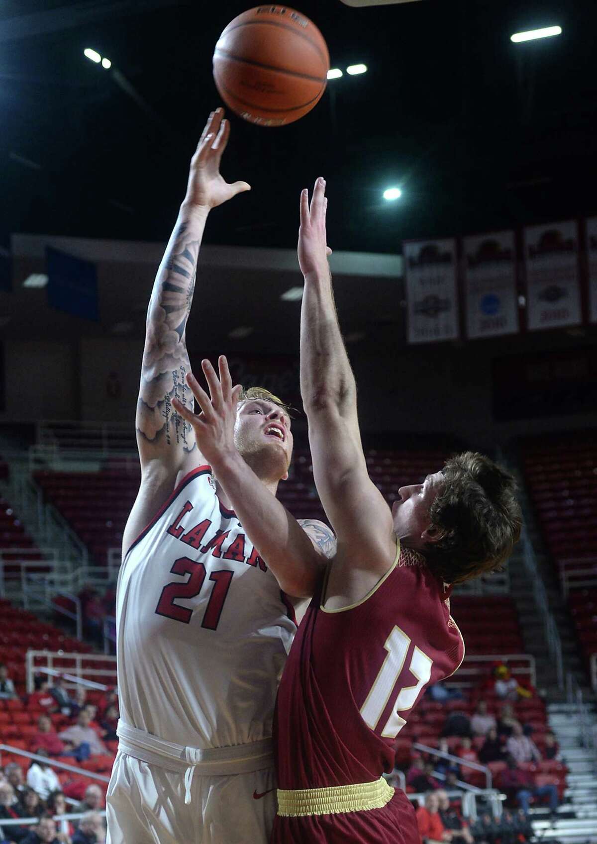 Lamar's Colton Weisbrod gets off a shot against the pressure of Austin College's Jeremy Swisher during Saturday's match-up at the Montagne Center. Photo taken Saturday, December 10, 2016 Kim Brent/The Enterprise