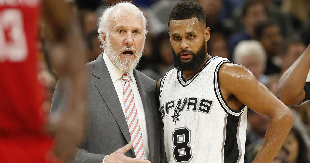 Spurs head coach Gregg Popovich talks with Patty Mills (08) in the game against the Houston Rockets during their game at the AT&T Center on Wednesday, Nov. 9, 2016.