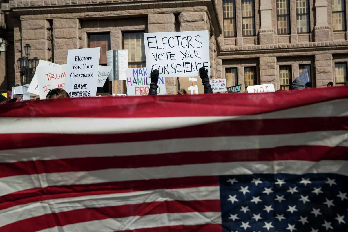 Demonstrators gather outside the Texas State Capitol in an attempt to influence the Republican electors from across the state to not vote for Donald Trump when they cast their formal ballots for president of the United States in Austin, Texas, Monday, Dec. 19, 2016. (AP Photo/Tamir Kalifa)