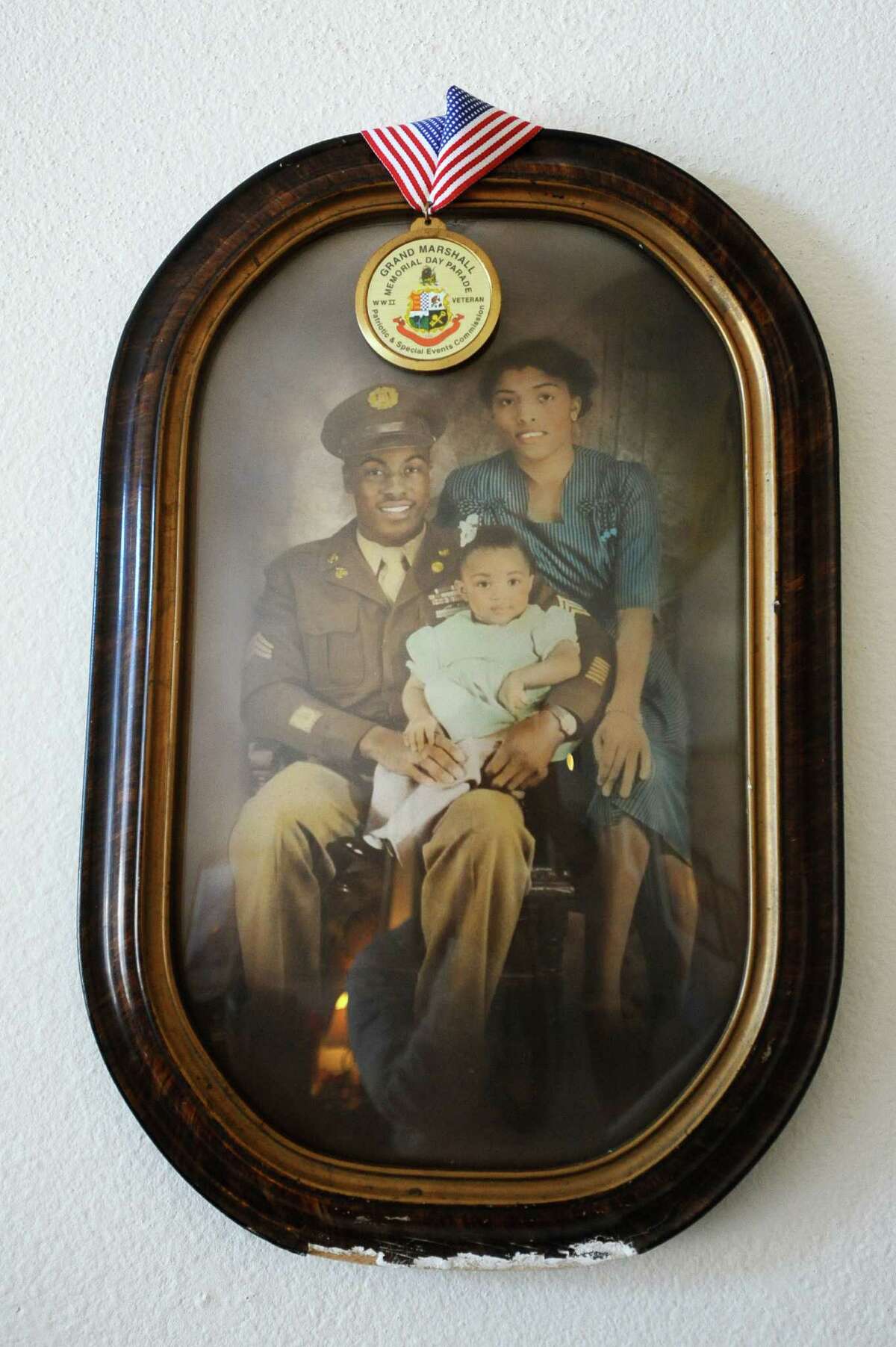 A family photo of young Archie Elam, with his parents inside his home on Glenbrook Rd. in Stamford, Conn. on Tuesday, Dec. 20, 2016. Elam's father served the U.S. Army in WWII.