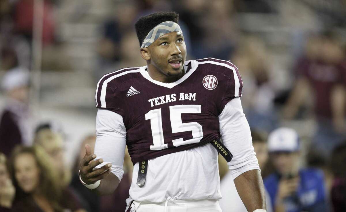 Texas A&M defensive lineman Myles Garrett (15) talks to teammates in between drills before the start of the game against Ole Miss on Nov. 12, 2016, in College Station.