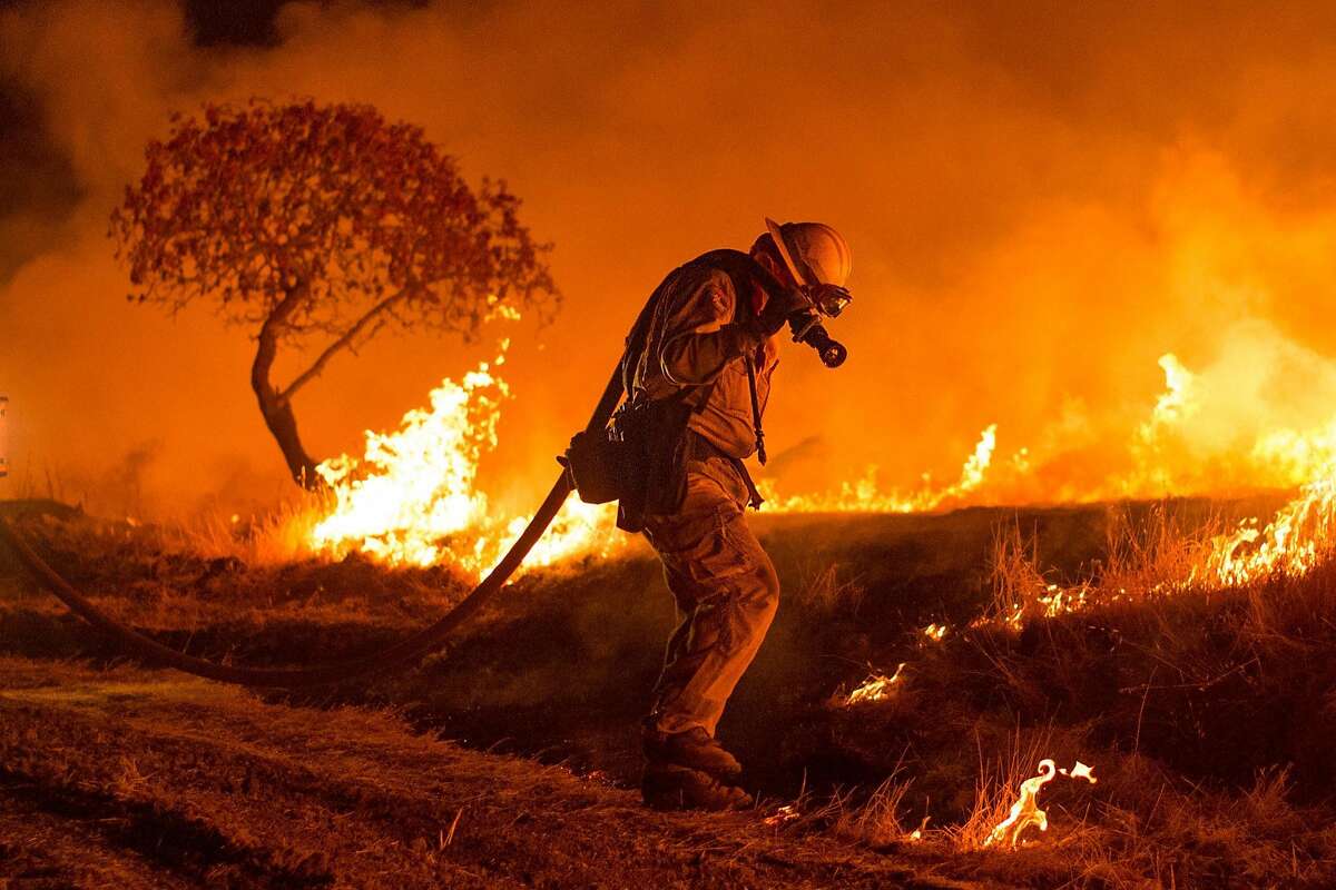 Firefighters set backfire while battling the Cold Fire near Winters, Calif., on Wednesday, Aug. 3, 2016.