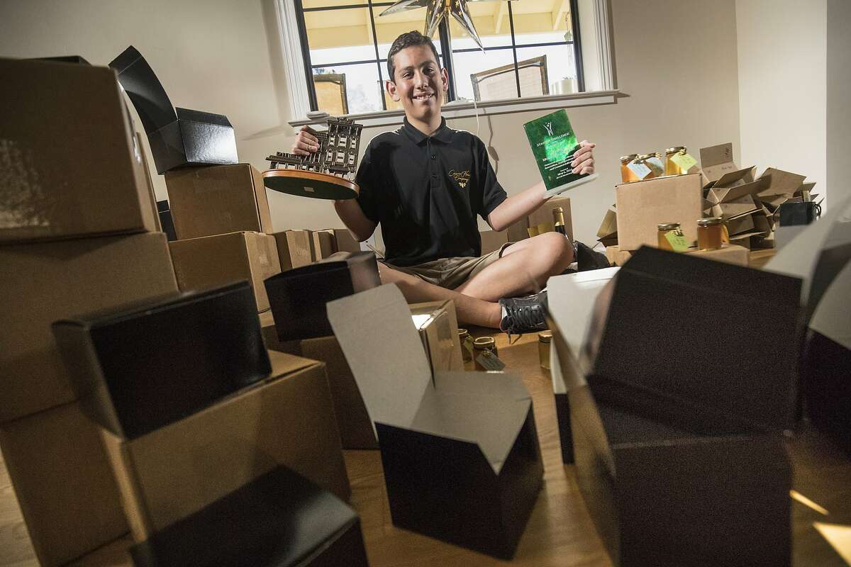Jake Reisdorf with his SCORE Outstanding Young Entrepreneur 2016 and CSUMB Startup Challenge Main Street Division Winner. He sits among 130 unfinished orders to go out to customers at his home on Saturday, Dec. 17, 2016 in Carmel , California. Carmel eighth-grader Jake Reisdorf is a self-described ?average 14-year-old who likes honey bees.? But he?s also an entrepreneur, having turned that interest into Carmel Honey Company, which supplies area markets, cheese shops and even BelCampo Meat Company in San Francisco. He?s the chief beekeeper who speaks on the topic to students, business owners, or at conferences around the country, and also donates to bee research and education