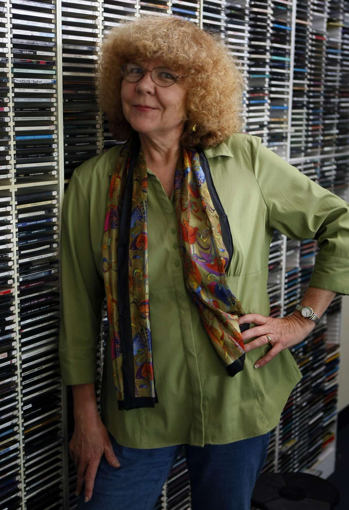 KFOG radio personality Rosalie Howarth stands in front of thousands of CD's in the On Air Studio in San Francisco Friday July 10, 2009