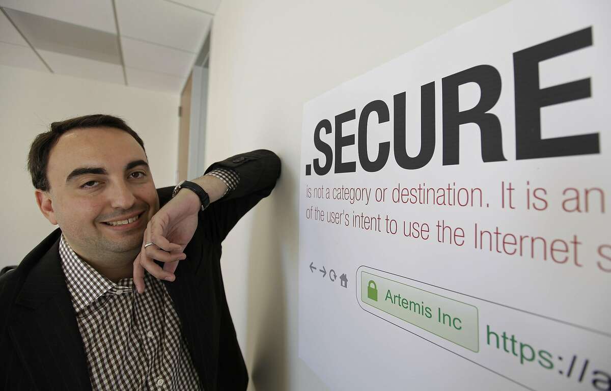 In this photo taken Friday, June 8, 2012 Alex Stamos, then CTO of Artemis Internet, an NCC Group Company, poses by a domain name poster at their offices in San Francisco. 
