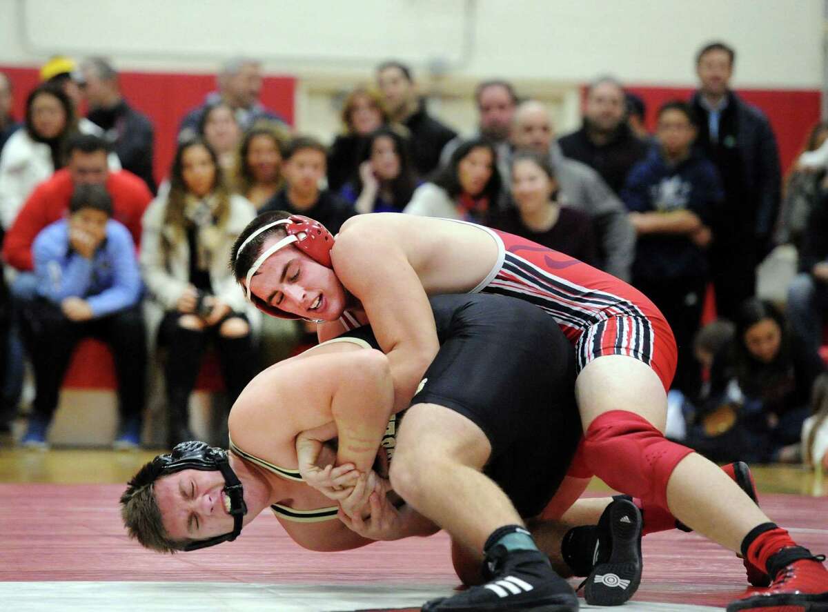 Greenwich’s Peyton Larkin, top, goes against Trumbull’s Joe Palmieri during their 195-pound match Wednesday at Greenwich High School. Larkin won the match with a 7-3 decision.