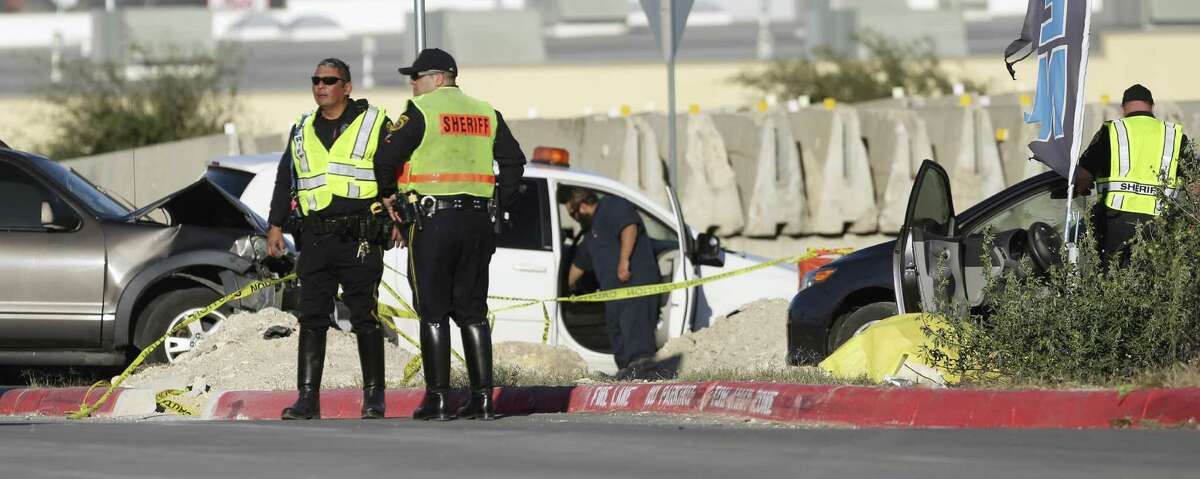 Sheriff's deputies guard the scene Wednesday, Dec. 21, 2016 in the 11200 block of Alamo Ranch Parkway, near the intersection of Texas 151 and Loop 1604, where a two vehicle crash left three people dead. One person died at the scene of the crash and two more people were transported to the hospital where they later died.